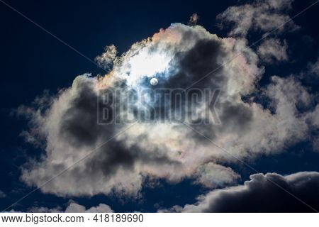 White Clouds With Iridescence Against The Blue Sky