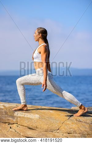 Female Athlete Practicing Yoga Streching Workout Outdoors By The Sea