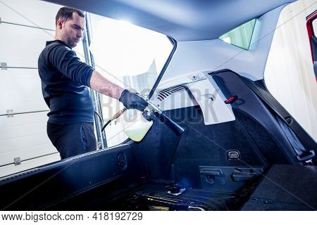 A Car Service Worker Cleans Interiror With A Special Foam Generator