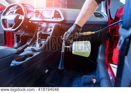 A Car Service Worker Cleans Interiror With A Special Foam Generator