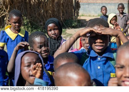 Mzuzu, Malawi. 30-05-2018. Portrait Of A Young Black Muslim. Girl With A Group Of Children Looking A
