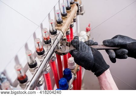 Pipefitter Install System Of Underfloor Heating System At Home