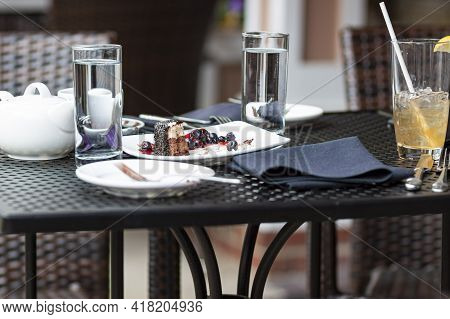 Leftover Food Waste Concept Image Featuring An Outdoor Cafe Table With No Customer But Leftover Cake