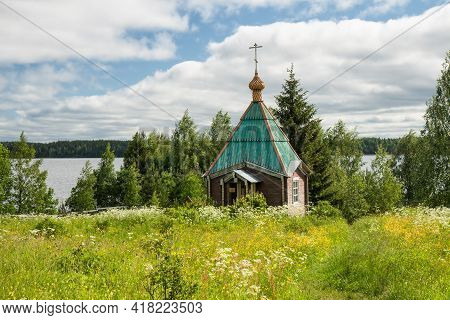 Small Wooden Chapel By The Lake. Vazheozersky Transfiguration Monastery, Karelia, Russia