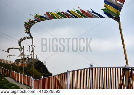 Yellow And White Iron Fencing With Flying Prayer Flags