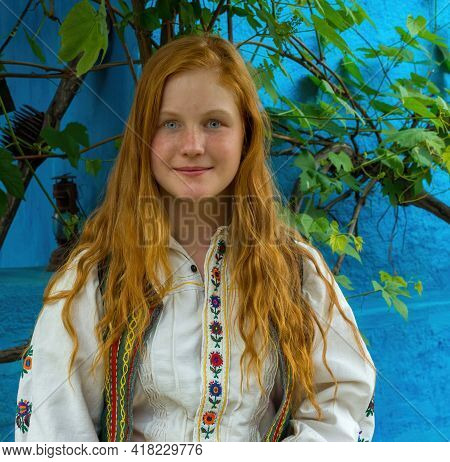 Salaj, Transylvania, Romania-may 14, 2018: Beautiful Freckled Young Girl With Red Hair And Blue Eyes