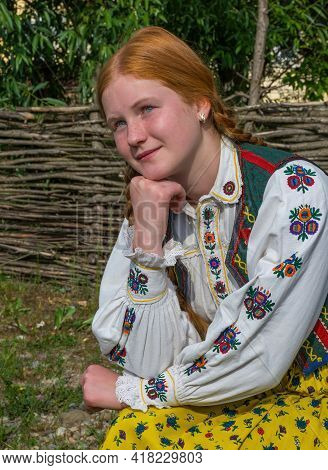 Salaj, Transylvania, Romania-may 14, 2018: Beautiful  Young Girl With Red Hair And Blue Eyes In Trad