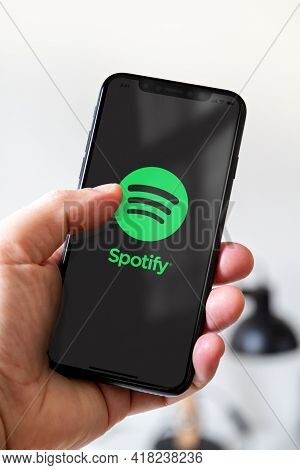 Paris - France - March 23, 2021 : Hand Holding Iphone Smartphone With Spotify Logo