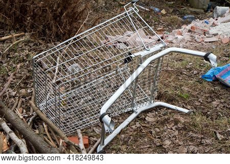 An Abandoned And Broken Shopping Cart Left Outdoor