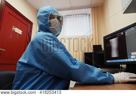 The Work Of A Radiologist In Antiviral Overalls In The X-ray Room For Diagnostics.