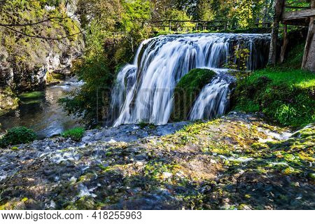 Scenic waterfall cascades on the river Sluncica. Magnificent Southern Europe, Croatia, small town Slunj. Beautiful sunny day. The concept of ecological, active and photo tourism