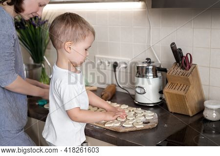 Portrait Cute Little Toodler Caucasian Boy Kid Cooking Sweet Tasty Cookies With Young Adult Mother A