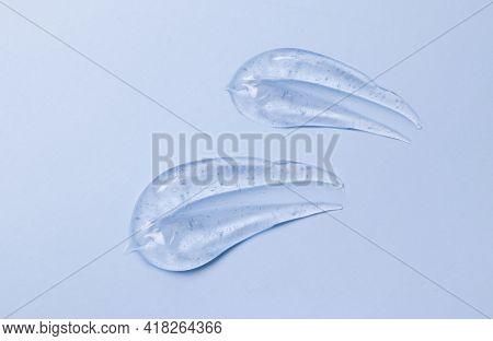 Thick Transparent Gel Smeared On A Blue Surface: Soap Texture, Antiseptic, Hyaluron Top View