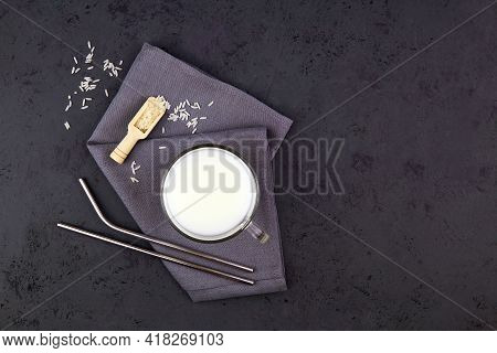 Rice Milk In A Glass Mug On A Dark Grey Background. Vegetable Milk. Vegan Lactose Free. Top View, Co