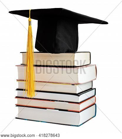 Graduate Cap With Yellow Tassel On Stack Of Books Isolated On White Background