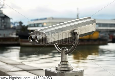Stationary Viewing Binoculars On The Background Of The Seaport. It's Raining. Selective Focus. Copy 