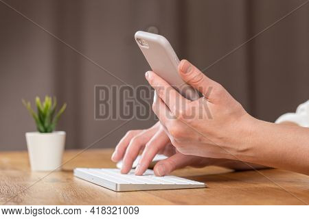 Hands Of Women Who Use Laptop Keyboard And Mobile Phone. Concept Of Email Delivery And Use Of Online