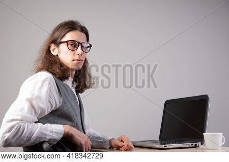Programming And Application Development, A Young Man Writes Code Sitting At A Laptop.