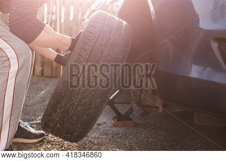 Car Wheel Replacement. Self-service Tire Fitting Concept. Installing A New Wheel. Winter And Summer 