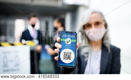 Senior Woman Showing Smartphone With Covidpass, Coronavirus, Travel And New Normal.