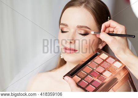 Wedding Make Up Artist Making Professional Bride Makeup. Bridal Eyeshadow Palette. Wedding Cosmetics