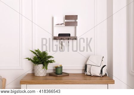 Wooden Hanger For Keys On White Wall In Hallway