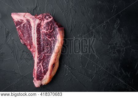 Dry Aged T Bone Marbled Beef Steak Set, On Black Stone Background, Top View Flat Lay, With Copy Spac