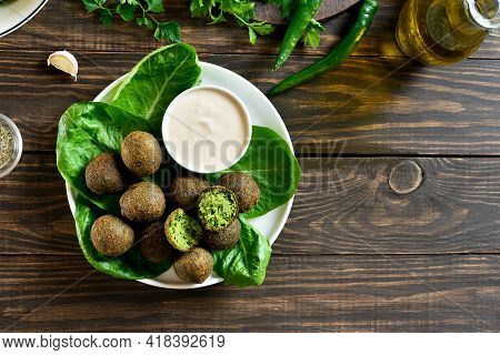 Falafel Balls. Deep Fried Balls From Ground Chickpeas. Traditional Middle Eastern Food. Wooden Backg