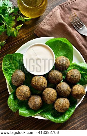Falafel Balls. Deep Fried Balls From Ground Chickpeas. Traditional Middle Eastern Food. Wooden Backg