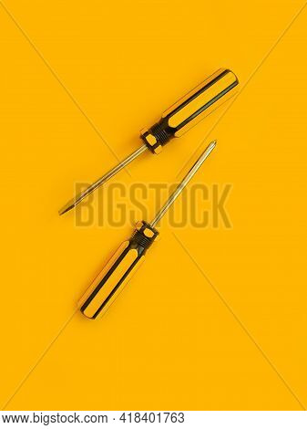 Screwdriver On A Colored Background Construction Steel