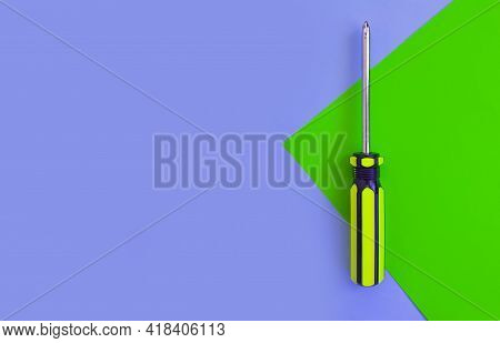 Screwdriver On A Colored Background Construction Steel