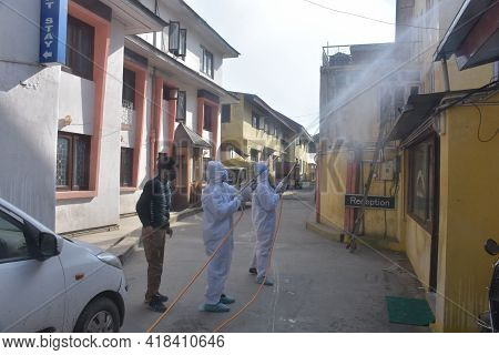 White Dressed Men Sanitizing City In Covid Lockdown.