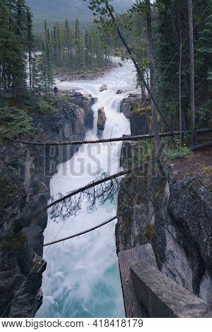 Vertical Shot Of Sunwapta Falls In Jasper National Park On A Dark And Cloudy Day. Harsh Weather In C