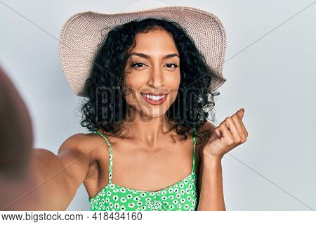 Young latin girl taking a selfie photo wearing summer style screaming proud, celebrating victory and success very excited with raised arm 