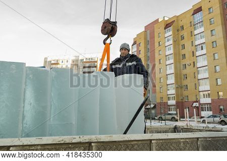 A Portrait Of A Fitter In A Blue Jacket At The Hook