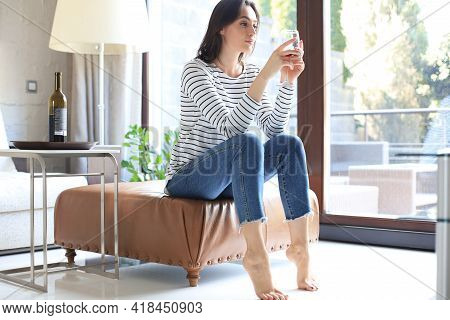 Successful Young Beautiful Woman Sitting On An Armchair In The Living Room, Drinking Red Wine.
