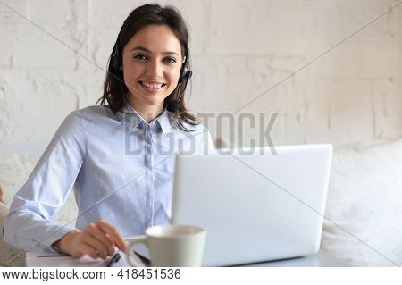 Freelance Operator Talking With Headsets And Consulting Clients From Home Office.