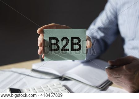 B2b, Btob Acronym, Word On Paper In Businessman Hand. Business Concept.