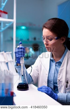 Healthcare Scientist Using Laboratory Dropper Micropipette During Vaccine Engineering