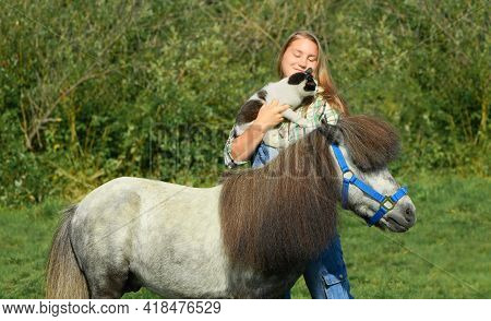 Happy Young Woman And Two Her Pets Are In Outdoors, The Close-up Portrait.