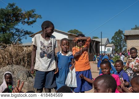 Mzuzu, Malawi. 30-05-2018. Group Of Smiling Black Children Gather In Front Of The Camera After Leavi