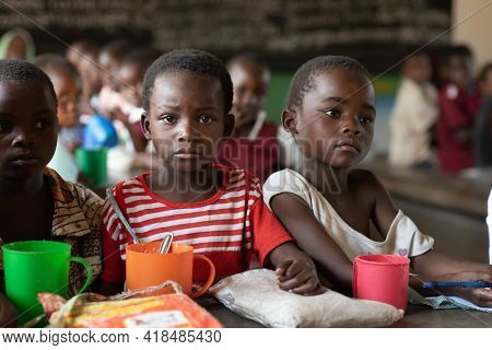 Mzuzu, Malawi. 30-05-2018. Group Of Afro-descendent Children Having Snack Inside Their Classroom Dur