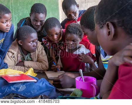 Mzuzu, Malawi. 30-05-2018. Group Of African Children Reunited Inside Their Classroom Working On An E