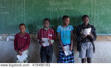 Mzuzu, Malawi. 30-05-2018. Group Of Black Children Are Standing In Front Of The Class Reading In A R