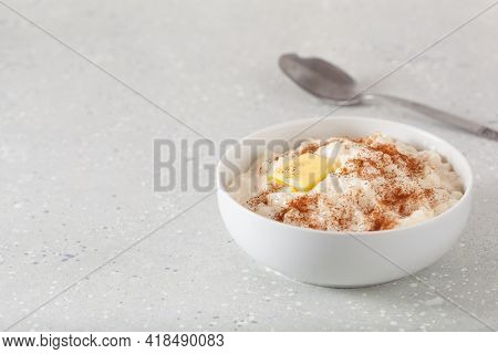 rice pudding with butter cinnamon. french riz au lait, norwegian risgrot, traditional breakfast dessert