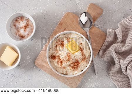 rice pudding with butter cinnamon. french riz au lait, norwegian risgrot, traditional breakfast dessert