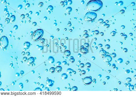 Close Up Macro Aloe Vera Gel Cosmetic Texture Blue Background With Bubbles. Lemongrass Gel Skincare 