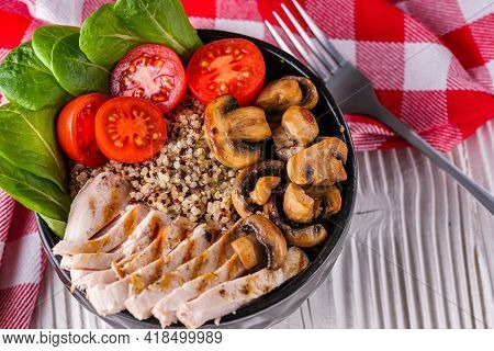 Bowl Of Healthy Quinoa With Grilled Chicken And Vegetables On A White Rustic Wooden Background