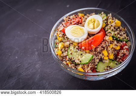 Bowl Of Healthy Quinoa With Vegetables On A Dark Rustic Background