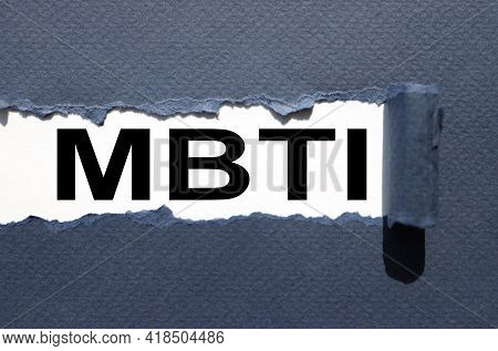Mbti. Text Inside Torn Blue Paper. White Sheet With Black Font.